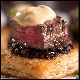  Mini golden puff pastry bites stuffed with beef tenderloin and mushroom duxelles.